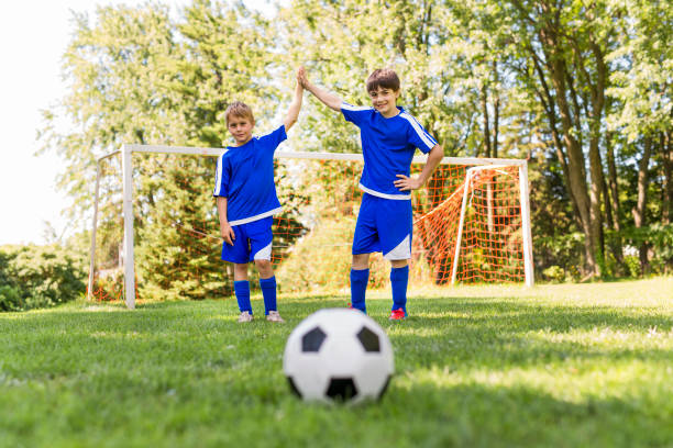 istock Two Young boy with soccer ball on a sport uniform 852986282