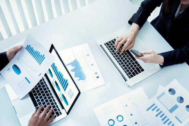 istock Desk businessman is using his laptop and documents as graphs. top view 852996012