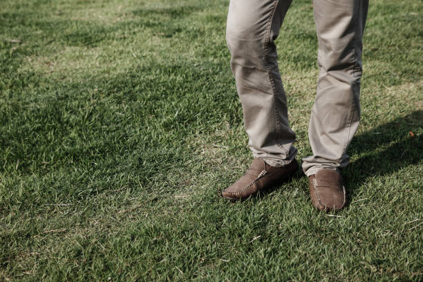 istock Man casual leather brown shoes is standing in a relaxed. 853071302