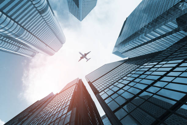 istock Plane flying over business skyscrapers 853082396