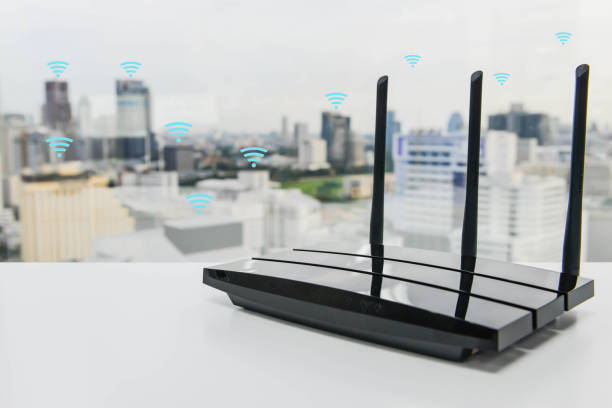 Black three poles wifi router on the white table