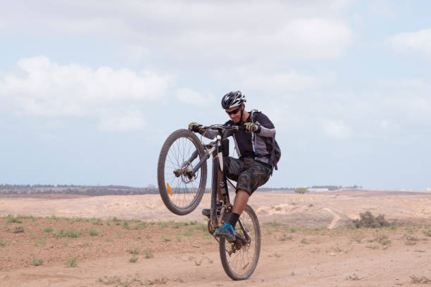 istock Pro rider performing wheelies on mountain bicycle. 853111260