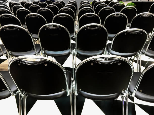 istock Back View of Black Chairs in Row 853114616
