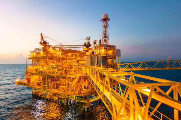 istock Offshore construction platform for production oil and gas with bridge in evening time 853116114