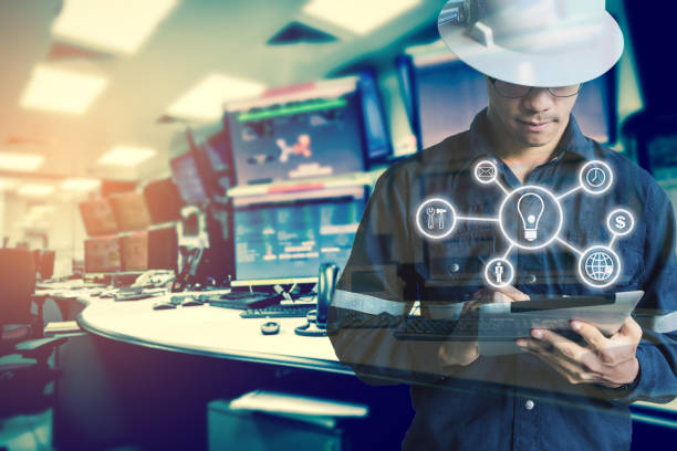 Double exposure of Engineer or Technician man with business industrial tool icons while using tablet with monitor of computers room  for oil and gas industrial business concept. stock photo