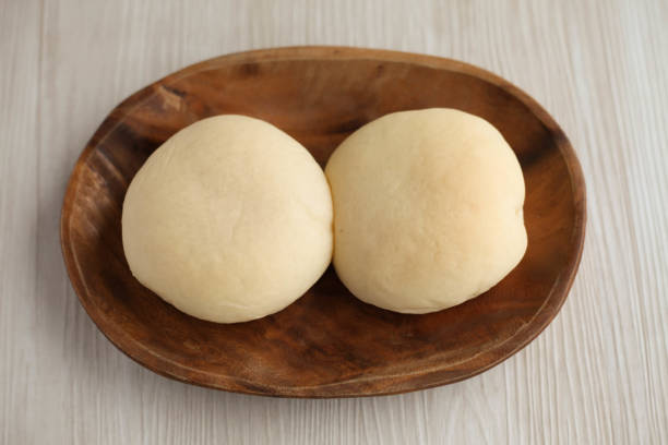 istock white bread on a wood plate isolated on table 853119730