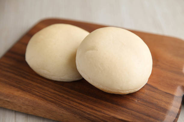 istock white bread on a wood cutting board isolated on table 853119912