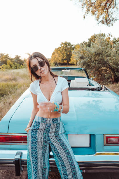 istock Girl posing on a background cabriolet 853124854