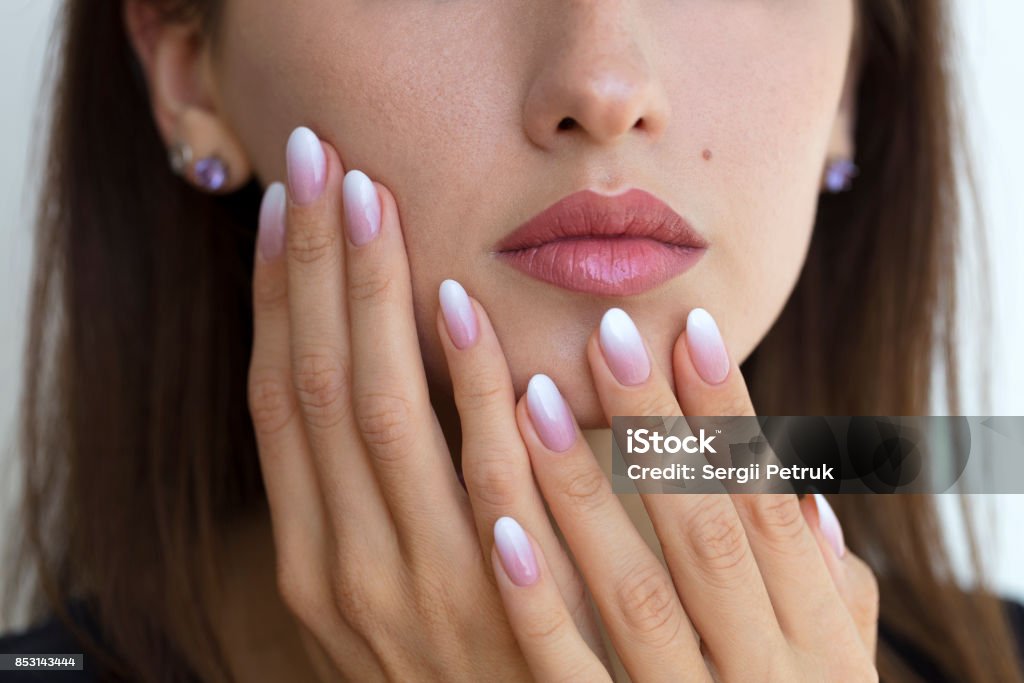 Beautiful woman's nails with beautiful french manicure ombre Beautiful woman's nails with beautiful french manicure ombre peach and white Ombre Stock Photo