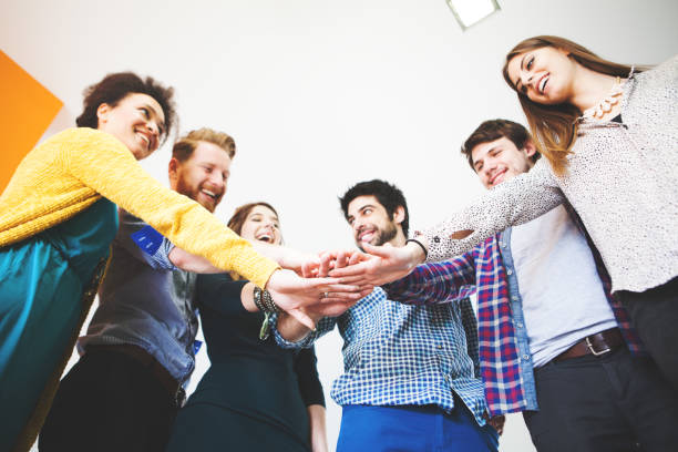 istock Group of young people with hands together 853150306