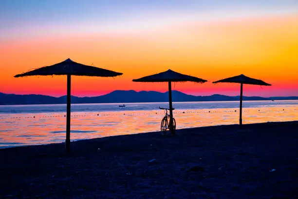 Photo of Beach and parasols on colorful sunset view, Adriatic sea, Zadar, Dalmatia region of Croatia