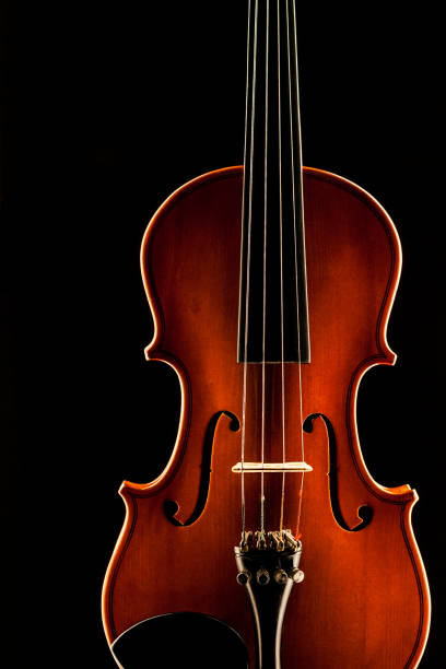 istock wooden violin on a black background 853160076