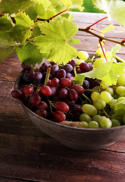 istock Grapes on wooden table and grape leaves . Healthy fresh wine grapes. 853162876