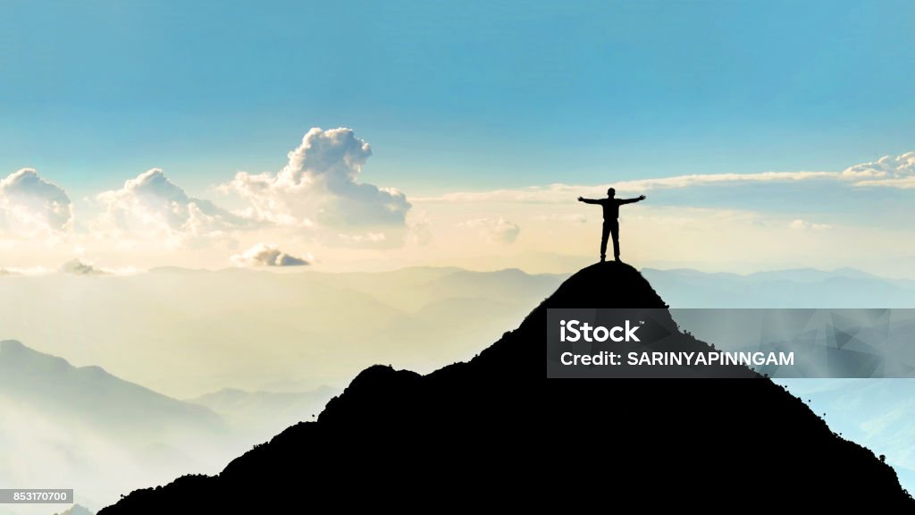 Businessman success raising arms stand on top of hill Mountain Stock Photo