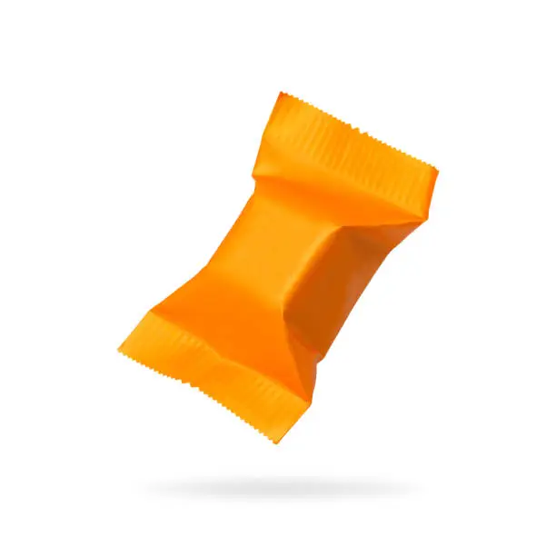 Photo of Candy packaging isolated on white background. Orange toffees product for your design. Clipping paths object.