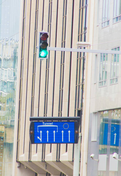 Roadsign directing towards the European Commission Headquarters Streetsign in Brussels, signalling the direction to the European Union's heradquarters, with a green traffic light european court of human rights stock pictures, royalty-free photos & images