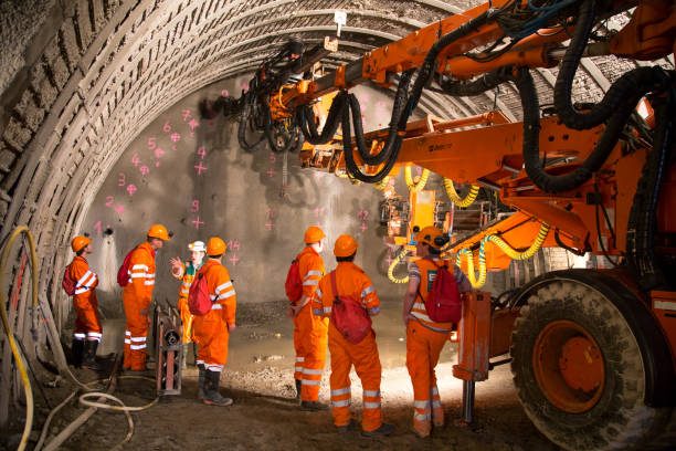 Tunnel piperoof grouting Geneva, Switzerland - May 22, 2014: Engineers and workers examinating the construction of piperoof grouting for tunnel construction mining natural resources photos stock pictures, royalty-free photos & images
