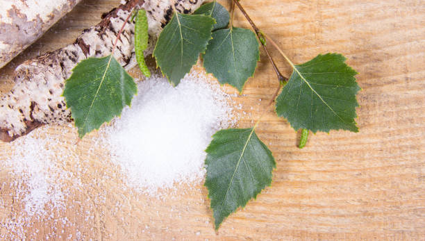 Xylitol - sugar substitute. Birch sugar on wooden background. stock photo