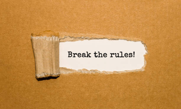 istock The text Break the rules appearing behind torn brown paper 853188854