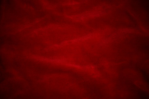Red velvet silk background of a dark shade