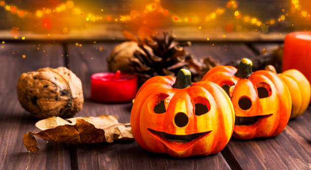 istock Pumpkins fall decoration, halloween celebration decorations with festive pumkins, chestnuts and acorns assortment with lights 853227620