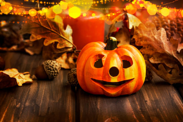 istock Pumpkins fall decoration, halloween celebration decorations with festive pumkins, chestnuts and acorns assortment with lights 853227654
