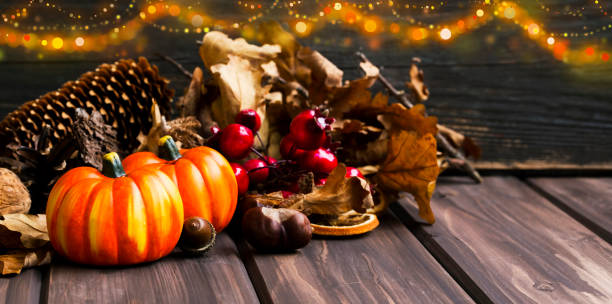 istock Pumpkins fall decoration, halloween celebration decorations with festive pumkins, chestnuts and acorns assortment with lights 853227682