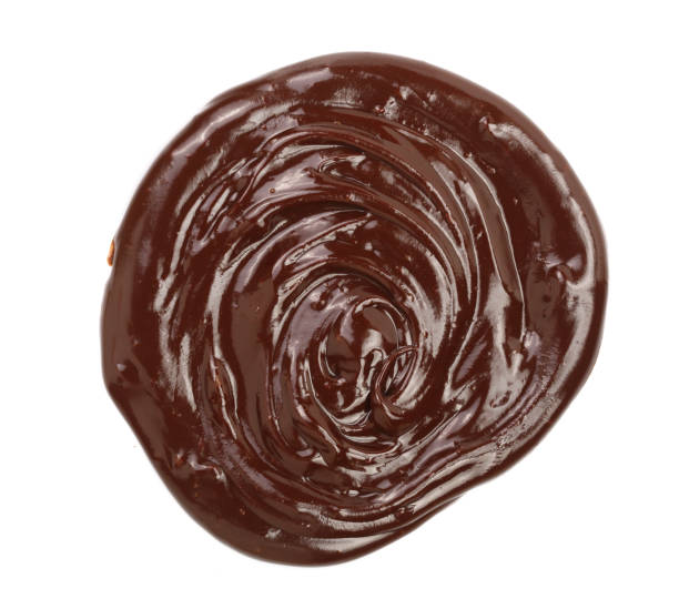 istock Hot melted chocolate pouring isolated on white background, top view 853230420