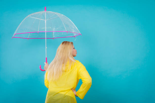 istock Blonde woman holding transparent umbrella 853230552