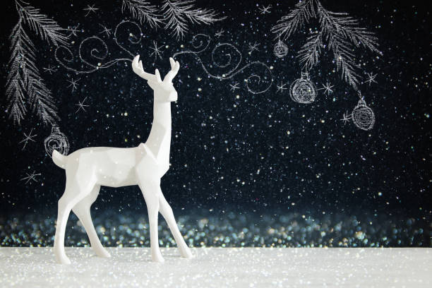 istock White reindeer on wooden table over chalkboard background whith hand drawn chalk illustrations. 853252434