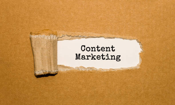 istock The text Content Marketing appearing behind torn brown paper 853254276