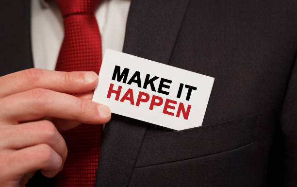 istock Businessman putting a card with text Make it happen in the pocket 853254346