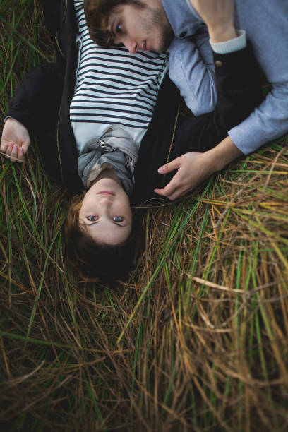 istock Heterosexual couple sitting  on the grass 853264704