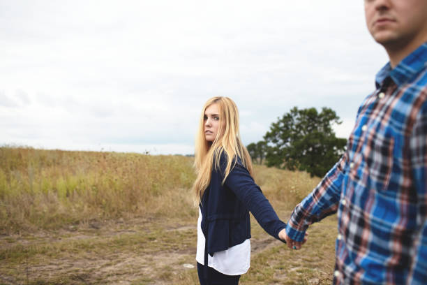 istock Heterosexual couple walking on the field in summer 853265064