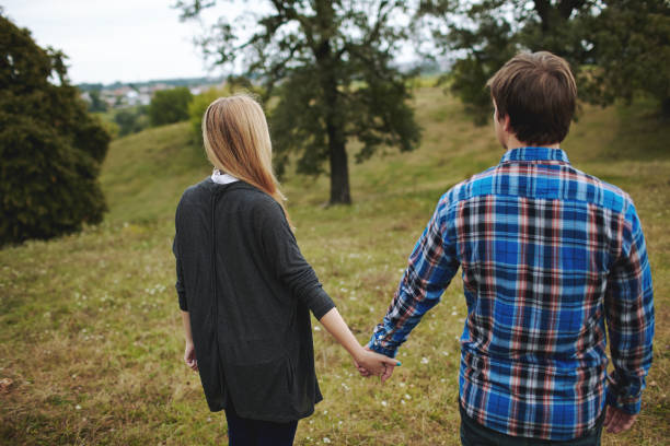 istock Heterosexual couple walking on the field in summer 853265100