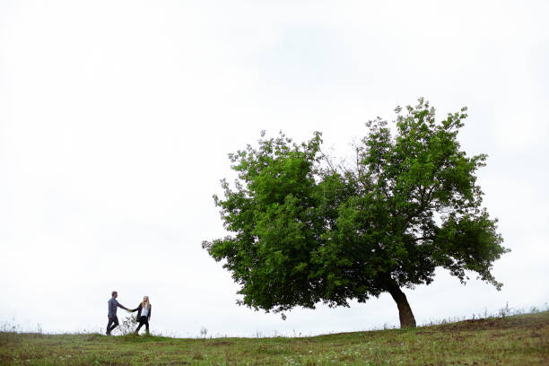 istock Heterosexual couple walking on the field in summer 853265238