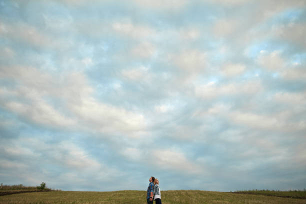 istock Heterosexual couple walking on the field in summer 853265336
