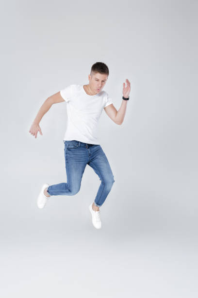 istock handsome man in jeans and jacket jumping 853274584