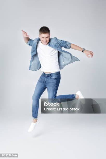 Handsome Man In Jeans And Jacket Jumping Stock Photo - Download Image Now - Men, Jeans, Only Men