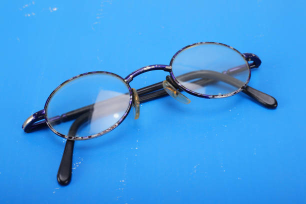 istock Retro man accessories - Old glasses on a blue leather background 853278066