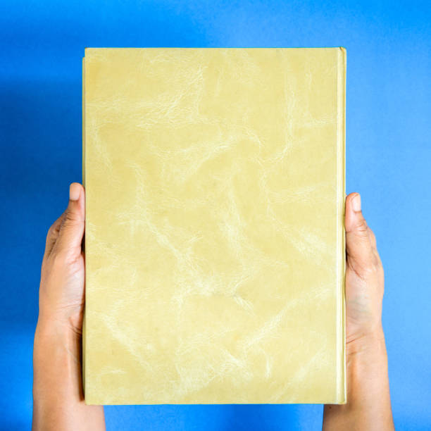 istock top view mock up book on hand and magazine text 853278488