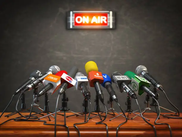 Press conference or interview on air.  Microphones of different mass media, radio, tv and press prepared for conference meeting. 3d illustration