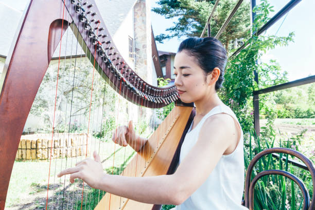 istock Woman Playing Harp Outdoors 853288876