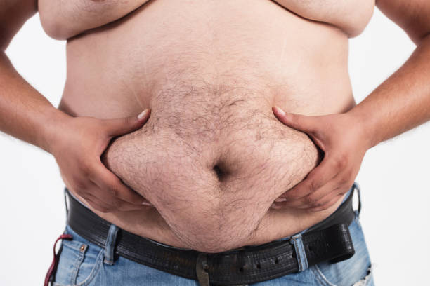 istock Man holding his big fat belly isolated on white background 853289580