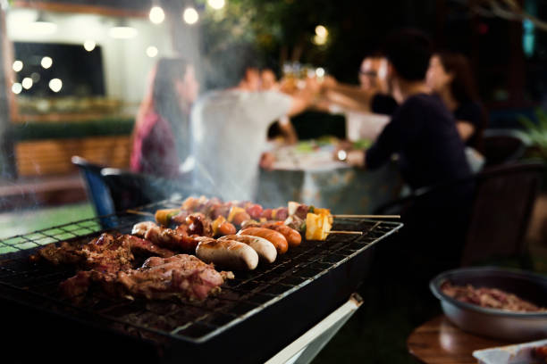 istock Dinner party, barbecue and roast pork at night 853292490