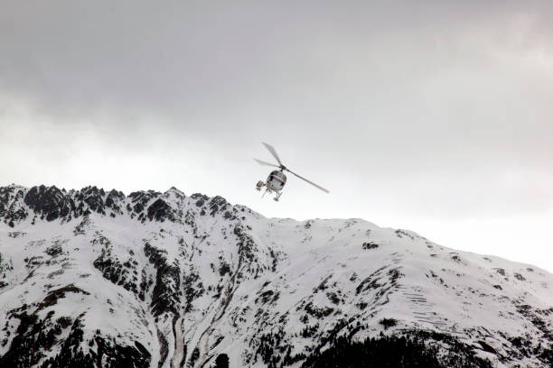 istock A helicopter flying over the alps 853302870