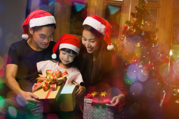 Asian family opening a gift box on christmas day happy stock photo