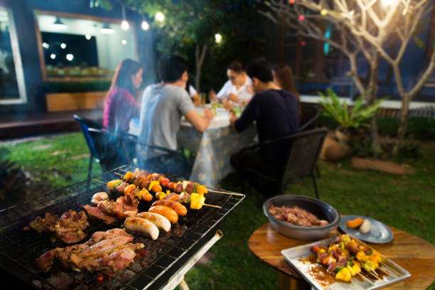 istock Dinner party, barbecue and roast pork at night 853303964