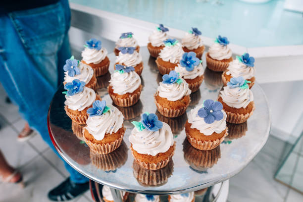 istock Cupcakes with whipped cream and frosting on a silver table in stainless steel 853313036