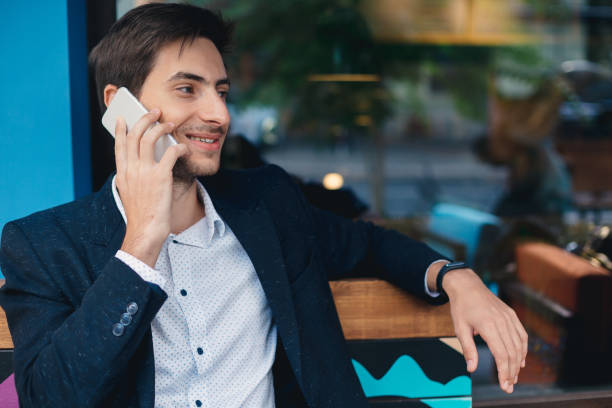 istock Portrait smiling young man talking on mobile phone 853329290